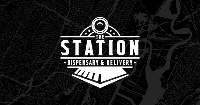 The Station - Image of The Station's white logo on a dark map background
